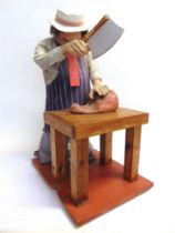 A BUTCHER'S SHOP DISPLAY AUTOMATON FIGURE in the form of a butcher standing at a block, with a