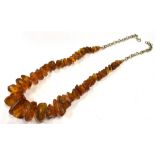 RAW AMBER & SILVER NECKLACE 50cm long, comprising numerous raw amber pieces, approx 8.6-23.3mm, on