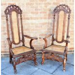 A PAIR OF CAROLEAN STYLE OAK HIGH BACK ELBOW CHAIRS late 19th century, each with a pierced scroll-