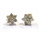 18CT GOLD & DIAMOND SET STUDS 7.6mm diameter, white gold floral clusters, claw set with round