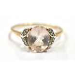 9CT GOLD & ROSE DANBURITE RING Central claw set oval mixed cut rose danburite, reported as 2.53