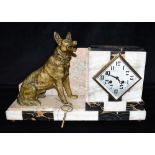 AN ART DECO MARBLE CASED MANTLE CLOCK with a patinated spelter figure of an alsatian dog, the French