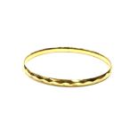 9CT GOLD METAL CORE BANGLE 8cm diameter, 5.7mm wide, with faceted decoration to exterior, smooth