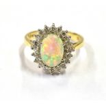 18CT OPAL & DIAMOND HALO RING White gold claw set white opal cabochon, with very good play of