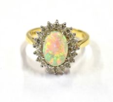 18CT OPAL & DIAMOND HALO RING White gold claw set white opal cabochon, with very good play of