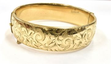 9CT ROLLED GOLD CUFF BANGLE 18.7mm wide, with scroll & foliate engraved front, hinge to one side and