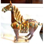 A CHINESE TANG STYLE SANCAI GLAZED POTTERY HORSE of large proportions, 109cm high.