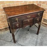 A MAHOGANY LOW BOY fitted with one long drawer and two short drawers, with brass carrying handles,