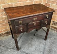 A MAHOGANY LOW BOY fitted with one long drawer and two short drawers, with brass carrying handles,