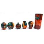 A GROUP OF SIX POOLE POTTERY VASES The Volcano pattern pillar vase is stamped 'Poole England' to the