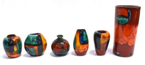 A GROUP OF SIX POOLE POTTERY VASES The Volcano pattern pillar vase is stamped 'Poole England' to the