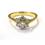 18CT GOLD & DIAMOND FLORAL CLUSTER RING White gold floral claw setting, with round brilliant cut