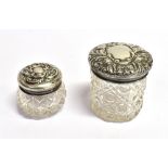 SILVER MOUNTED CUT CRYSTAL COSMETIC POTS Two pretty silver topped pots decorated with floral and