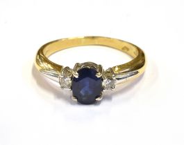 MODERN SAPPHIRE AND DIAMOND RING Central oval cut mid blue sapphire approx 7.1 x 5.2mm (estimated