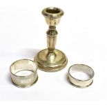 SILVER CANDLE STICK & NAPKIN RINGS A dainty sterling silver single candlestick, stands approx 10cm