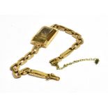 9CT GOLD EMPTY WATCH CASE Rectangular watch case, stamped 375, with rolled gold bracelet strap.