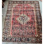 A NORTH WEST PERSIAN MALAYER RUG the central red ground with a bordered edge, 176cm x 138cm
