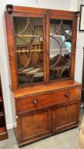 A WILLIAM IV MAHOGANY BOOKCASE WITH LINE INLAID DECORATION the bookcase with pair of doors enclosing