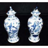 A PAIR OF CHINESE PORCELAIN LIDDED VASES underglaze blue painted decoration of birds, butterflies