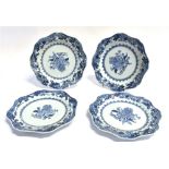 FOUR CHINESE EXPORT PLATES underglaze blue enamelled decoration within a shaped border, 23cm