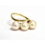 WHITE CULTURED PEARL 14CT GOLD RING Three approx 6.6-6.9mm round white pearls obliquely set in a