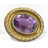 GEORGIAN AMETHYST BROOCH 9ct gold brooch with a fine canetille frame surrounding an oval mixed cut