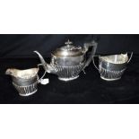 VICTORIAN STERLING SILVER TEA SERVICE Teapot with ebony handle and finial decorated with gadrooned