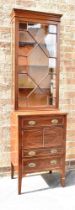 AN EDWARDIAN INLAID MAHOGANY TALL CABINET the upper glazed section with three shelves and with