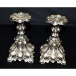 SWEDISH SILVER CANDLESTICKS A pair of baroque style candlesticks, with Swedish hallmarks for silver,