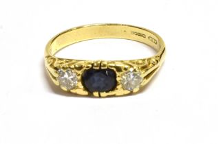 SAPPHIRE & DIAMOND THREE STONE RING Set in 18ct yellow gold, a round mixed cut dark blue sapphire,