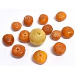 RAW AMBER BEADS Twelve irregular shaped raw amber beads, ranging from 15.0-20.5mm diameter and 9.5-