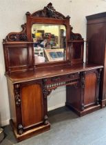 A VICTORIAN MIRROR BACK SIDEBOARD well carved with vine leaves and grapes, the central mirror back