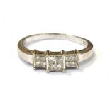 18CT WHITE GOLD & DIAMOND RING A channel and invisibly set head with princess cut diamonds, est