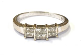 18CT WHITE GOLD & DIAMOND RING A channel and invisibly set head with princess cut diamonds, est