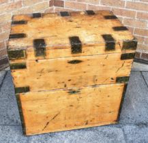 A RECTANGULAR METAL BOUND PINE TRUNK with pair of brass carrying handles and fall front cupboard