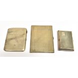 THREE STERLING SILVER CIGARETTE CASES Two decorated with fine engine turning and one plain with