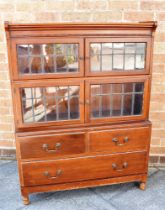 A MAHOGANY BOOKCASE with two pairs of leaded glazed doors over and with two short and one long