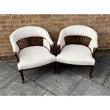 A PAIR OF EDWARDIAN HOOP BACK TUB CHAIRS with railed back rests and turned frontal supports, with