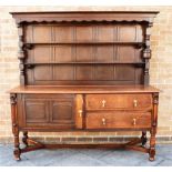 A LARGE OAK DRESSER the upper section with two shelves, base with cupboard and pair of drawers,