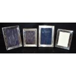 ASSORTED SILVER PICTURE FRAMES Four rectangular, silver mounted picture frames with elegant,