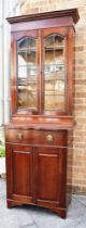 AN EDWARDIAN MAHOGANY BOOKCASE CABINET the upper section with lead glazed doors enclosing three