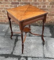 AN EDWARDIAN MAHOGANY CARD TABLE the baize lined interior with dished counter wells, frieze