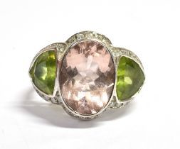 MORGANITE, PERIDOT & DIAMOND RING Central bezel set morganite, estimated 4.36 carats, flanked by