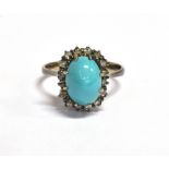 TURQUOISE & DIAMOND RING Central oval turquoise cabochon, approx 10.7 x 7.0mm, surrounded by a