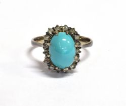 TURQUOISE & DIAMOND RING Central oval turquoise cabochon, approx 10.7 x 7.0mm, surrounded by a