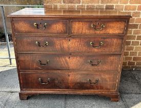 A GEORGIAN MAHOGANY RECTANGULAR CHEST of two short and three long drawers, with brass loop handles