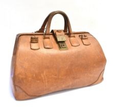 A TAN LEATHER POLO/HUNTING BAG with twin carrying handles and a pair of fastening straps and with