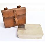 A SHAPED RECTANGULAR FOLDING PLATED SANDWICH CASE contained in a tan leather holder for saddle