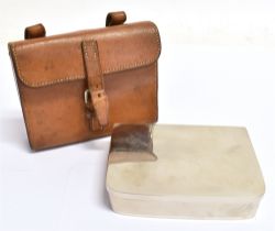 A SHAPED RECTANGULAR FOLDING PLATED SANDWICH CASE contained in a tan leather holder for saddle
