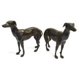 A PAIR OF BRONZED FIGURES OF STANDING WHIPPETS height 30cm, length 36cm